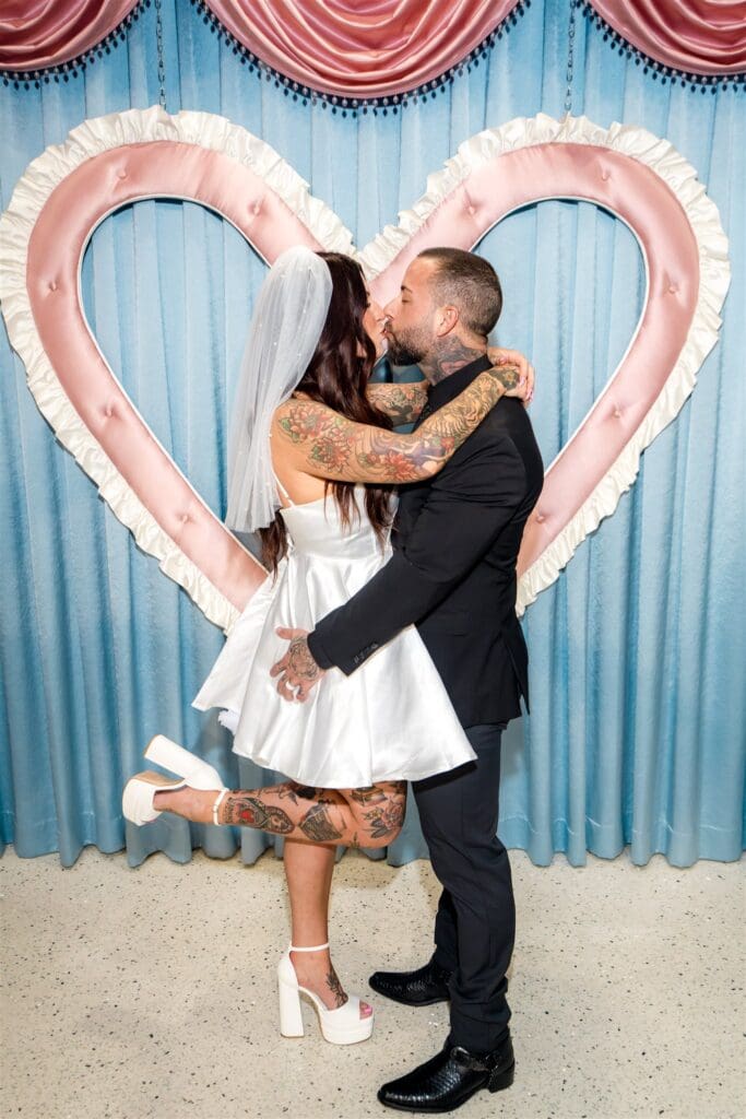 cute picture of the couple kissing during their photoshoot