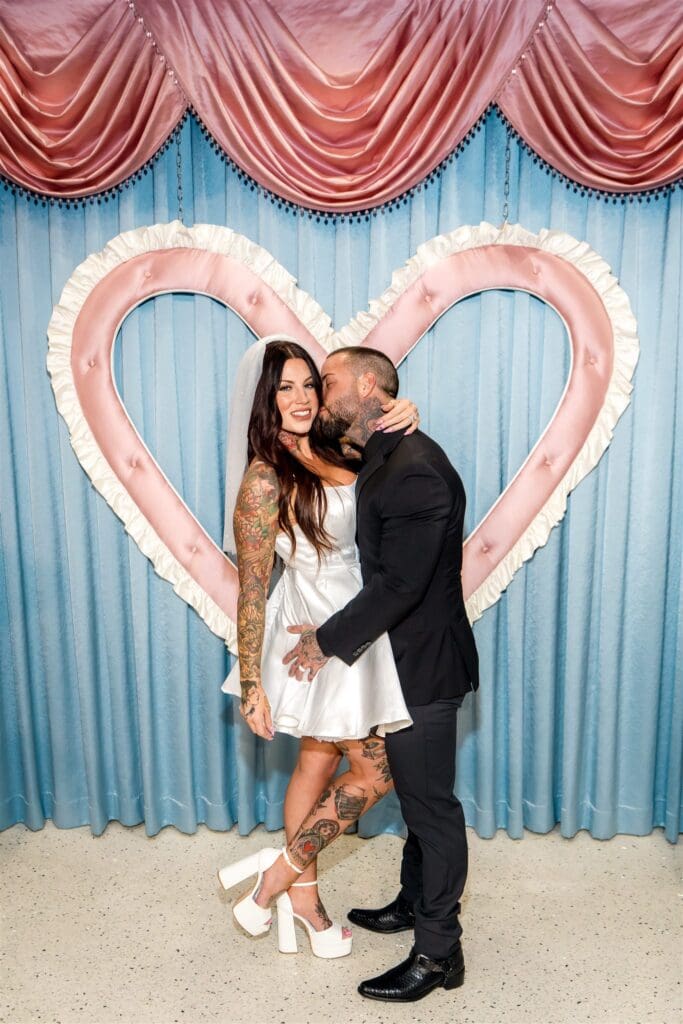 groom kissing the bride on the cheek