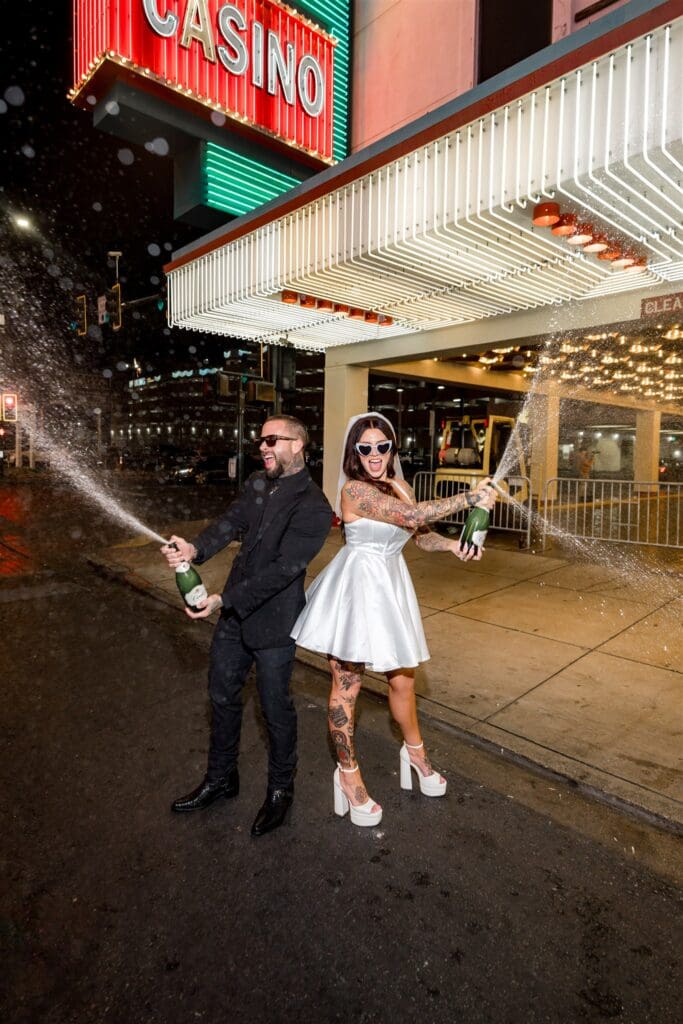 couple celebrating their vow renewal with champagne