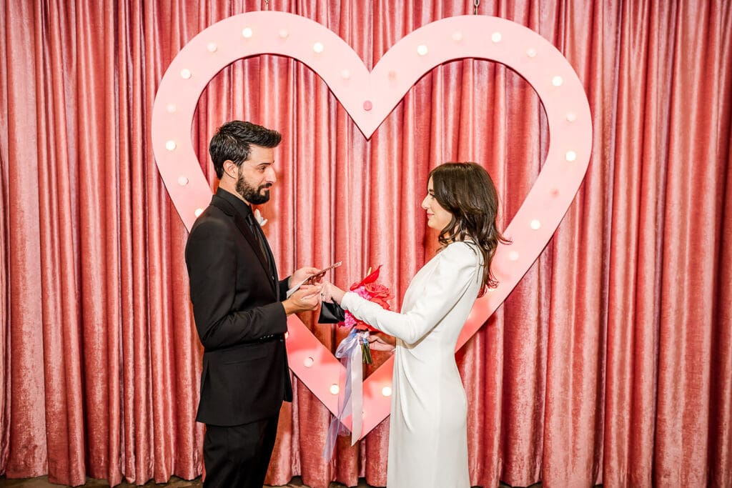 cute picture of the bride and groom holding hands during their ceremony